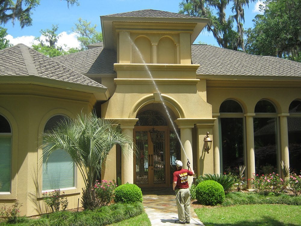 Professional washing exterior of large house