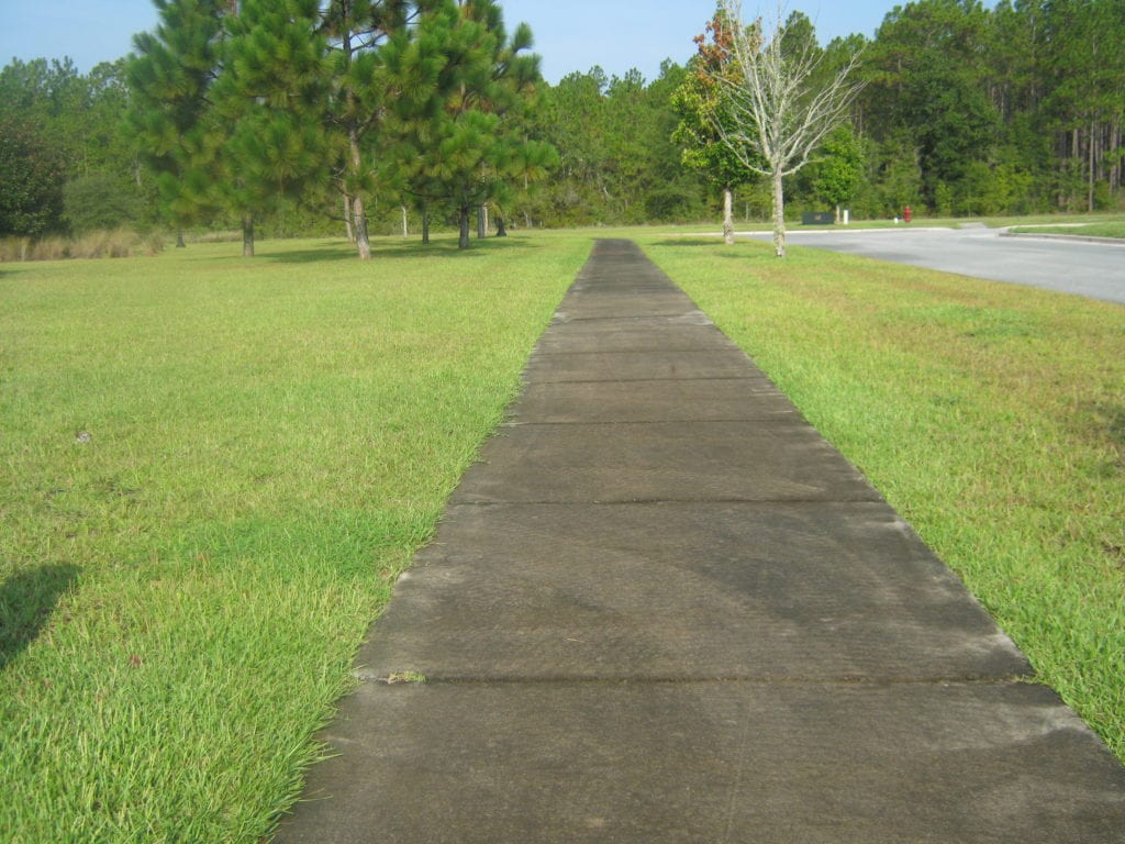 Long dirty sidewalk.