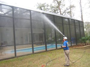 Soft washing a pool enclosure
