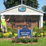 A photo of the Killearn Lakes Plantation main entrance sign being soft washed by a professional cleaning service.