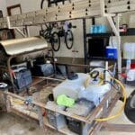 A corroded steel pressure washing trailer being disassembled after five years of use.