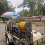 A clean and corrosion-free aluminum pressure washing trailer being used on a jobsite, showing its excellent condition after 3.5 years of service.