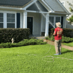 Nick Loomis of Hot Water Pressure Washing performing a professional Soft Wash House Washing service to restore a home's exterior in the Southwood neighborhood of Tallahassee, Florida.