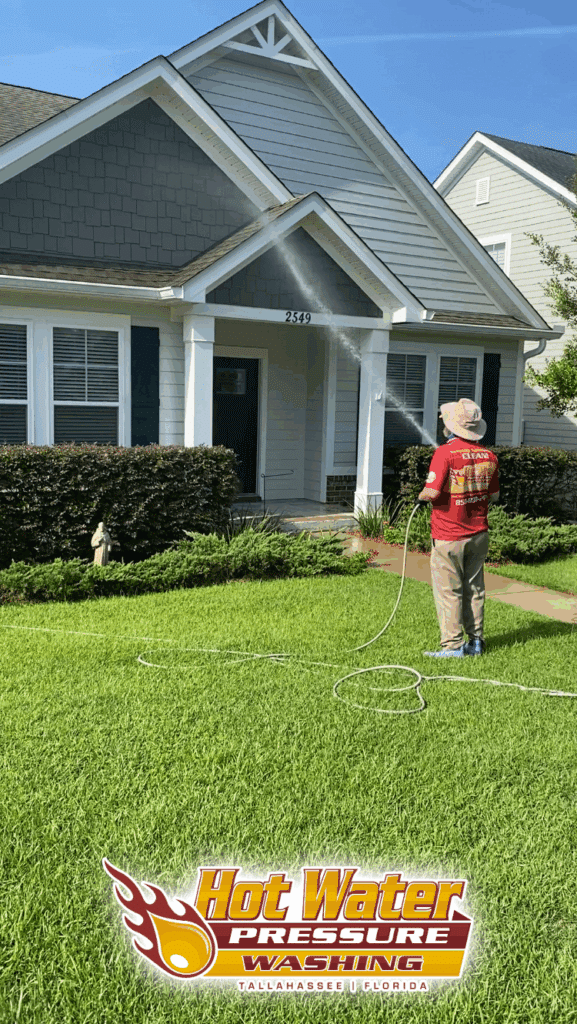 Nick Loomis of Hot Water Pressure Washing performing a professional Soft Wash House Washing service to restore a home's exterior in the Southwood neighborhood of Tallahassee, Florida.
