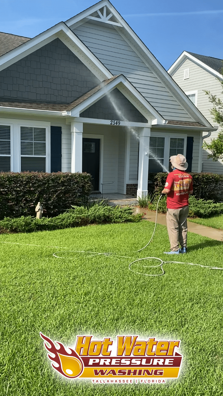 Nick Loomis of Hot Water Pressure Washing performing a professional Soft Wash House Washing service to restore a home's exterior in the Southwood neighborhood of Tallahassee, Florida.