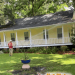 Rinsing a massive wrap-around porch during a complete property cleaning project at a beautiful home in Havana, Florida.