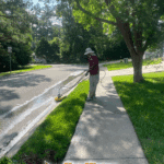 Using a professional surface cleaner to pressure wash a concrete curb and remove grime in the Killearn Commons neighborhood of Tallahassee, FL.