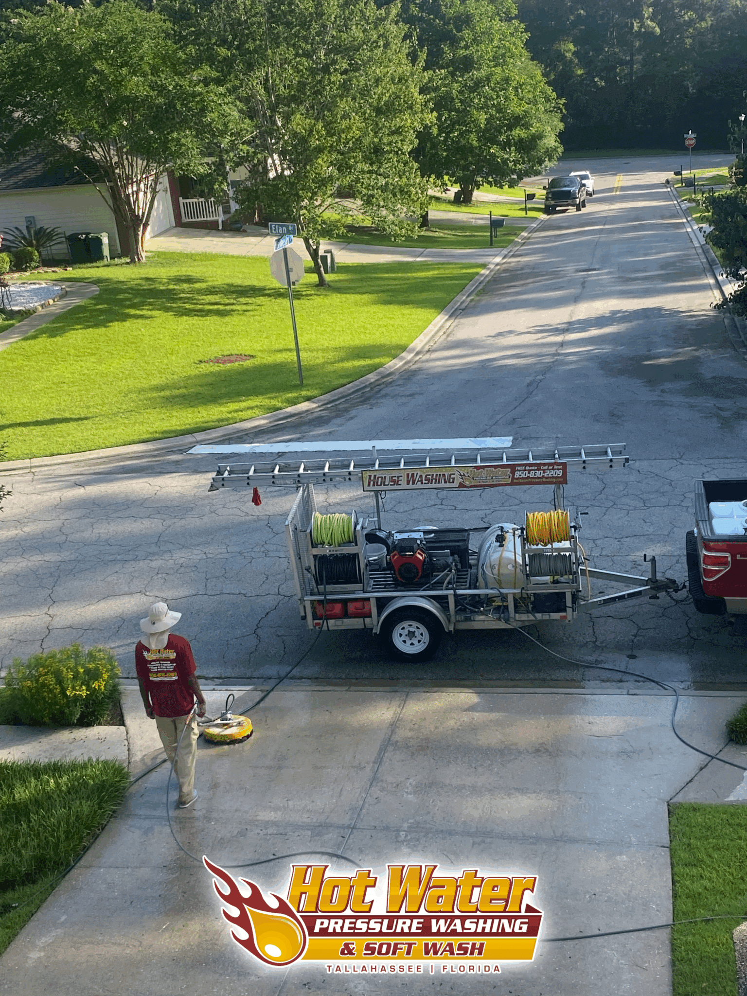 An overhead view of a technician using a surface cleaner to pressure wash a concrete driveway in the Killearn Commons neighborhood of Tallahassee, FL