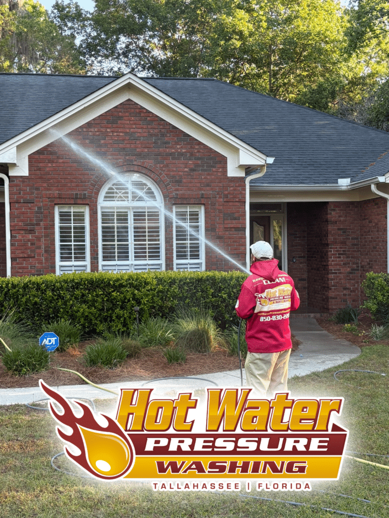 Nick Loomis of Hot Water Pressure Washing safely performing a professional Soft Wash House Washing on the exterior of a residential home in the Summerbrooke neighborhood of Tallahassee, Florida.