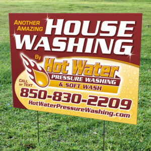 Yard sign advertising hot water pressure washing and soft washing services in Tallahassee, Florida